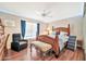 Well-lit bedroom with a comfortable bed and a relaxing armchair at 18903 N 97Th Ln, Peoria, AZ 85382