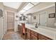 Elegant bathroom with double vanity and a large walk-in shower at 18903 N 97Th Ln, Peoria, AZ 85382