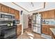 Modern kitchen with stainless steel appliances and wood cabinetry at 18903 N 97Th Ln, Peoria, AZ 85382