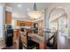 Kitchen with breakfast bar, wood cabinets, and a view into the entryway at 1663 S Boulder St, Gilbert, AZ 85295