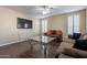 Spacious living room with dark hardwood floors and large TV at 1663 S Boulder St, Gilbert, AZ 85295
