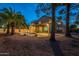 Evening view of the house and backyard with a pool and landscaping at 1663 S Boulder St, Gilbert, AZ 85295