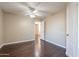 Bedroom with wood flooring, ceiling fan and access to another room at 1663 S Boulder St, Gilbert, AZ 85295