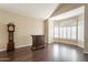 Living room with hardwood floors, bay window with shutters, and grandfather clock at 1663 S Boulder St, Gilbert, AZ 85295