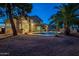 Relaxing backyard oasis with a pool, lighting, and desert landscaping at 1663 S Boulder St, Gilbert, AZ 85295
