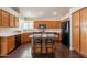 Kitchen boasts an island, wood cabinets, and dark flooring at 1663 S Boulder St, Gilbert, AZ 85295