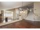 Open dining room with hardwood floors, chandelier, and loft view at 1663 S Boulder St, Gilbert, AZ 85295
