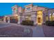 Two-story house with three car garage and landscaping at 1663 S Boulder St, Gilbert, AZ 85295