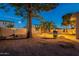 Landscaped backyard at dusk with pool and fire pit at 1663 S Boulder St, Gilbert, AZ 85295