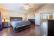 Primary bedroom with dark wood floors, a king bed, and access to loft area at 1663 S Boulder St, Gilbert, AZ 85295