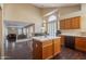 Open concept kitchen with island, wood cabinets, and high ceilings at 1663 S Boulder St, Gilbert, AZ 85295