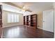Bedroom with wood flooring, plantation shutters, and built-in shelving at 1663 S Boulder St, Gilbert, AZ 85295