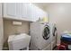 Laundry room with washer, dryer, and utility sink at 1663 S Boulder St, Gilbert, AZ 85295