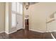 Two-story entryway with hardwood floors, white door, and plantation shutters at 1663 S Boulder St, Gilbert, AZ 85295