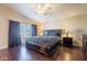 Main bedroom with dark wood flooring and a king-size bed at 1663 S Boulder St, Gilbert, AZ 85295