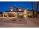 Two-story house with three car garage and landscaping at 1663 S Boulder St, Gilbert, AZ 85295