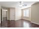 Bedroom with ceiling fan, wood flooring, and access to another room at 1663 S Boulder St, Gilbert, AZ 85295