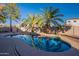 Inviting kidney-shaped pool with palm trees and a rock waterfall feature at 1663 S Boulder St, Gilbert, AZ 85295
