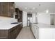 Modern kitchen featuring granite countertops, stainless steel appliances, and dark wood cabinets at 735 E Marblewood Way, Phoenix, AZ 85048