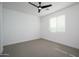 Spacious bedroom with ceiling fan and neutral carpeting at 735 E Marblewood Way, Phoenix, AZ 85048