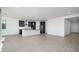 Open concept kitchen and living area with light wood-look tile floors at 735 E Marblewood Way, Phoenix, AZ 85048