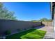 Landscaped backyard with artificial turf and a paved patio area at 735 E Marblewood Way, Phoenix, AZ 85048