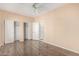 Bedroom with wood floors, double closets, and ceiling fan at 25575 W Lynne Ln, Buckeye, AZ 85326