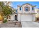 Two story house with attached garage and landscaping at 25575 W Lynne Ln, Buckeye, AZ 85326