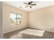 Bright bedroom with wood-look floors and a ceiling fan at 25575 W Lynne Ln, Buckeye, AZ 85326