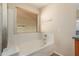 Bathroom with a bathtub and window at 25575 W Lynne Ln, Buckeye, AZ 85326