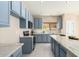 Kitchen with blue cabinets, marble countertops and stainless steel appliances at 25575 W Lynne Ln, Buckeye, AZ 85326