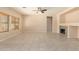 Living room with stone fireplace and tile floors at 25575 W Lynne Ln, Buckeye, AZ 85326