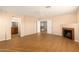 Bedroom with wood floors, fireplace and access to bathroom and upper floor at 25575 W Lynne Ln, Buckeye, AZ 85326