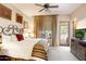 Comfortable bedroom with king-size bed and private patio access at 27440 N Alma School Pkwy # 116, Scottsdale, AZ 85262