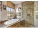 Spa-like bathroom featuring a soaking tub and walk-in shower at 27440 N Alma School Pkwy # 116, Scottsdale, AZ 85262