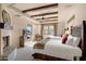 Guest bedroom with two twin beds and a fireplace at 27440 N Alma School Pkwy # 116, Scottsdale, AZ 85262