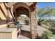 Built-in outdoor kitchen with a grill and stone countertops at 27440 N Alma School Pkwy # 116, Scottsdale, AZ 85262
