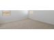 Well-lit bedroom featuring neutral carpet and window with blinds at 25383 W Sunland Ave, Buckeye, AZ 85326