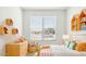 Cozy bedroom with light wood dresser and colorful bedding at 25383 W Sunland Ave, Buckeye, AZ 85326