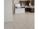 Modern kitchen with dark brown cabinets and a large island at 25383 W Sunland Ave, Buckeye, AZ 85326