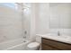 Clean bathroom with a bathtub, marble shower surround, and modern vanity at 25383 W Sunland Ave, Buckeye, AZ 85326
