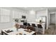 Modern kitchen with white cabinets, island, and stainless steel appliances at 25383 W Sunland Ave, Buckeye, AZ 85326