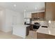 Modern kitchen featuring island, stainless steel appliances, and white quartz countertops at 25383 W Sunland Ave, Buckeye, AZ 85326