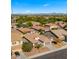 Aerial view of a house and neighborhood, featuring a palm tree in the front yard at 1138 E Regent Dr, Gilbert, AZ 85298