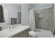 Bathroom with gray tile shower and quartz countertop at 18527 N 98Th Way, Scottsdale, AZ 85255