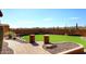 Landscaped backyard with green lawn, desert plants, brick walkway, and stucco wall at 38820 N 19Th Way, Phoenix, AZ 85086