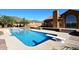Inviting backyard oasis with a sparkling pool, diving board, and covered patio area at 38820 N 19Th Way, Phoenix, AZ 85086