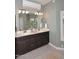 Modern bathroom with double vanity, dark cabinets, and light tile floors at 38820 N 19Th Way, Phoenix, AZ 85086