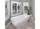 Elegant bathroom with a soaking tub and plantation shutters at 38820 N 19Th Way, Phoenix, AZ 85086