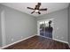Empty bedroom with sliding glass doors, wood-look tile flooring, and ceiling fan at 38820 N 19Th Way, Phoenix, AZ 85086
